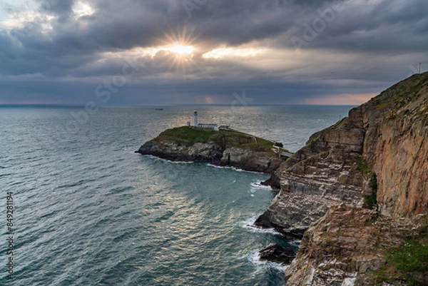 Fototapeta Sun beams around South Stack Lighthouse