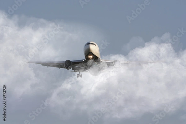 Obraz Airliner through the clouds