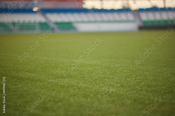 Fototapeta A green soccer field featuring white line markings for soccer games and competitions