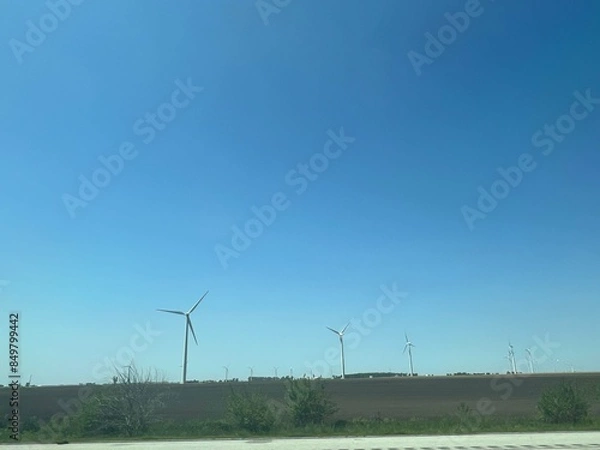 Fototapeta Panoramic view of wind farm or wind park, with high wind turbines for generation electricity with copy space. Green energy concept.