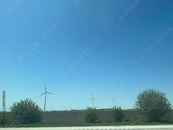 Fototapeta Panoramic view of wind farm or wind park, with high wind turbines for generation electricity with copy space. Green energy concept.