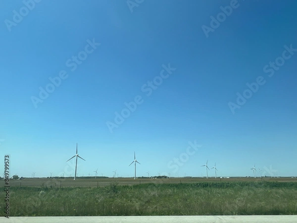 Fototapeta Panoramic view of wind farm or wind park, with high wind turbines for generation electricity with copy space. Green energy concept.