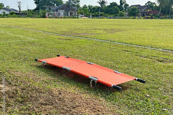 Fototapeta orang stretcher on the field ready to be use if accident happen in the game.