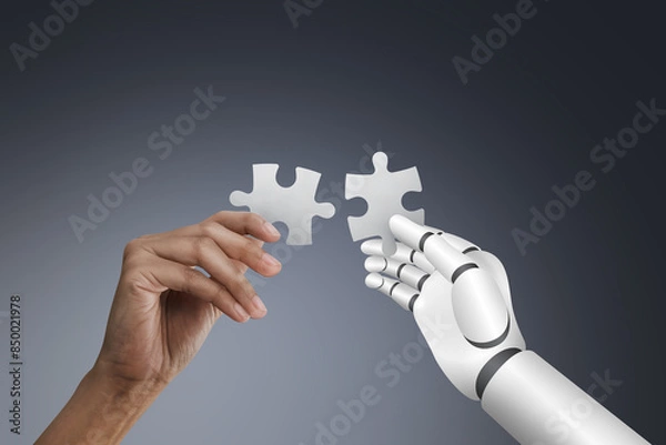 Fototapeta Human hand and Robotic hand holding puzzle on dark background, collaboration and innovation concept.