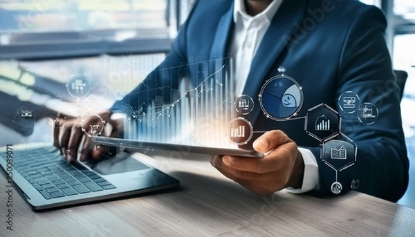 Fototapeta Businessman using tablet and laptop analyzing sales data and economic growth graph chart. Business strategy. Digital marketing. Business innovation technology concept