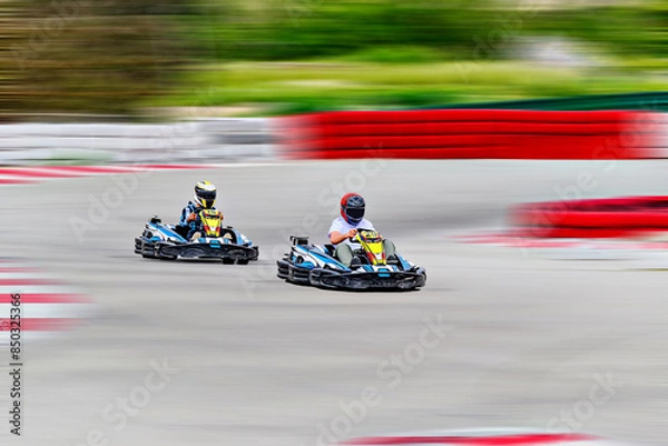 Fototapeta Young racers competing with karts on a Karting circuit in Barcelona. Lifestyle