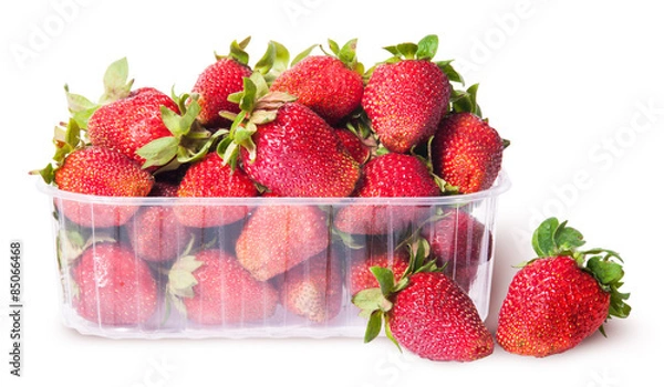 Fototapeta Freshly strawberries in a plastic tray and two near