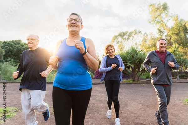 Fototapeta Group of diverse senior people jogging together at park