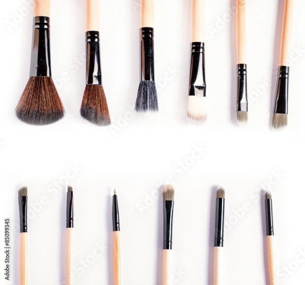 Obraz Makeup brushes on white background, top view