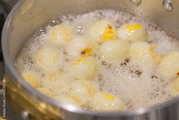 Obraz Boiled quail eggs with water and then fried them with oil in the pan.