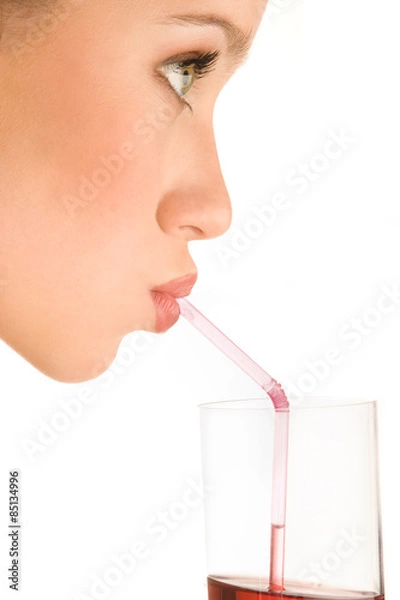 Fototapeta Drinking juice. Side view, close-up