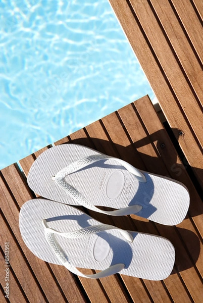 Fototapeta White flipflops by pool side