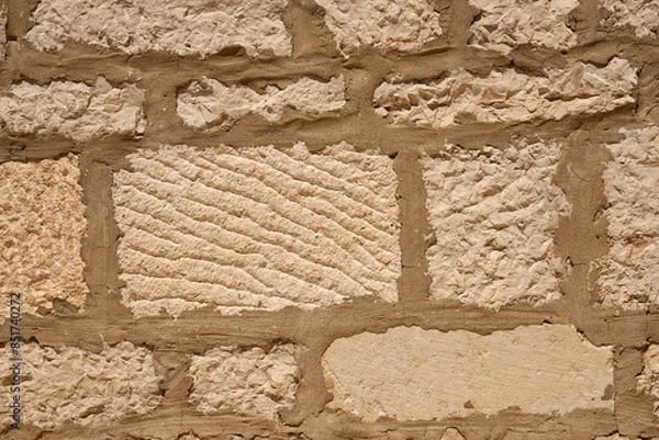 Obraz A wall of stones on mortar as a background.