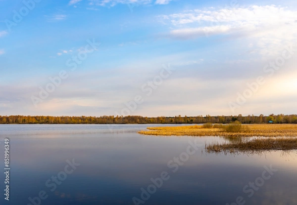 Fototapeta A lake with a cloudy sky in the background