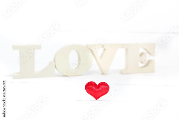Fototapeta Word love with heart shaped on white wooden background. Valentines Day background