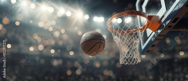 Fototapeta Basketball player making a slam dunk, focus on ball and hoop, with crowd in background, photorealistic, dynamic, sports arena