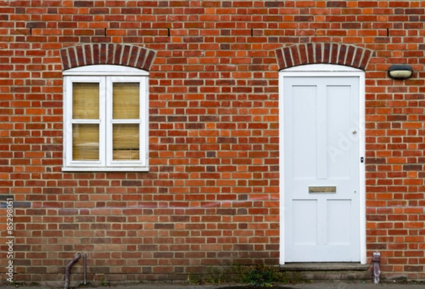 Fototapeta White door and window on brick wall background.