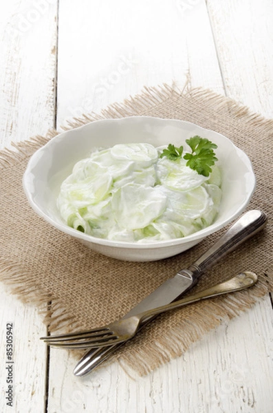 Fototapeta cucumber salad with sour cream and parsley