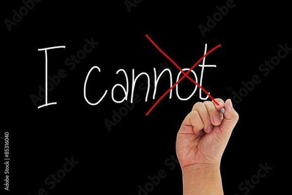 Fototapeta Hand with pen writing I cannot to give positive thinking and motivation isolated on black background.