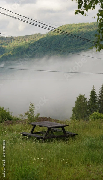 Fototapeta Picnic table in foggy mountains early morning