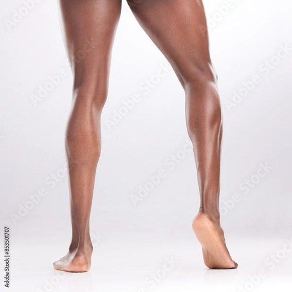 Fototapeta Person, legs and muscular in studio with fitness for workout progress, exercise goals and wellness. Bodybuilder, strong athlete and flexing thighs for healthy body and gym muscles on white background