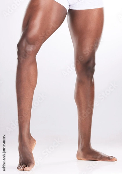 Fototapeta Man, legs and muscles in studio with fitness for workout progress, exercise goals and wellness. Bodybuilder, muscular athlete and flexing thighs for healthy body and gym target on white background