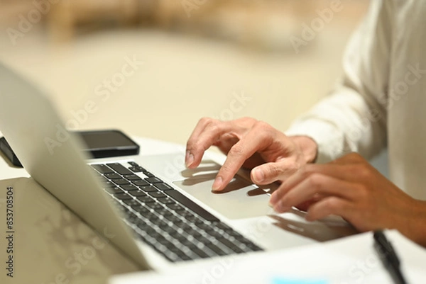 Fototapeta Businessman typing at laptop keyboard browsing internet or searching information