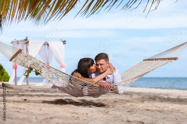 Fototapeta Romantic Couple Relaxing In Beach Hammock