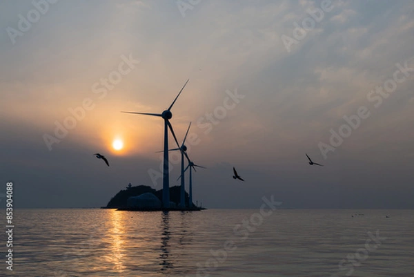 Fototapeta View of the wind turbines and flying seagulls during sunset on the sea