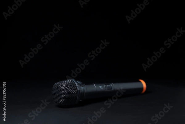 Fototapeta Black and silver microphones in the studio on a black and dark background. Professional recording equipment. Top view.