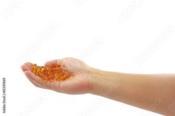 Fototapeta Handful of fish oil capsules isolated on pure white background