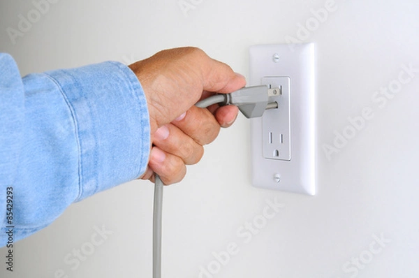 Fototapeta Closeup Man With Plug and Outlet