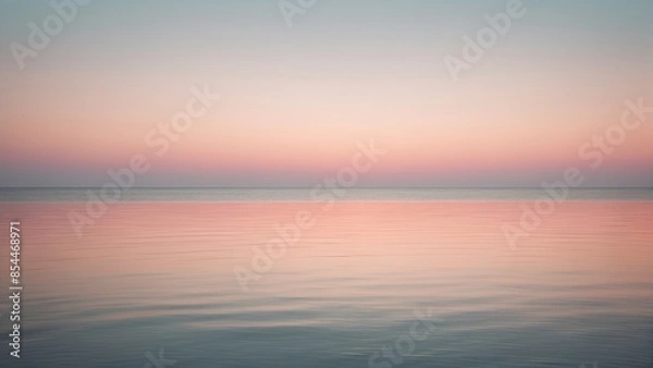 Fototapeta A peaceful seascape with a soft pastel pink sunset reflecting on the calm ocean waters, background, wallpaper