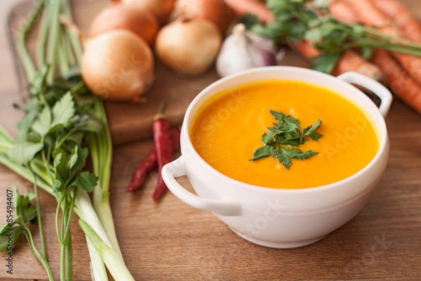 Obraz carrot soup with vegetables on wood table