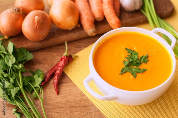 Obraz carrot cream soup on the wood table