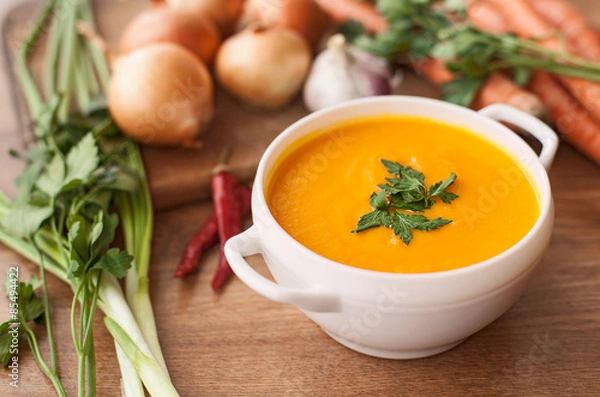 Obraz carrot soup with vegetables on wood table