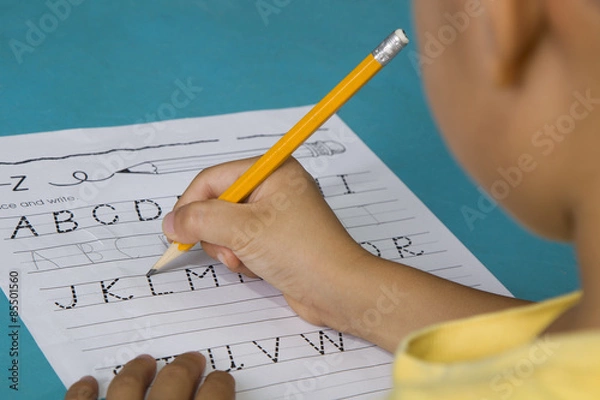 Obraz Asian boy traces the letter L with partial blurred view of the face