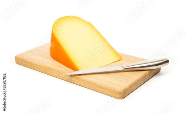 Fototapeta Yellow cheese and kitchen knife on a cutting board