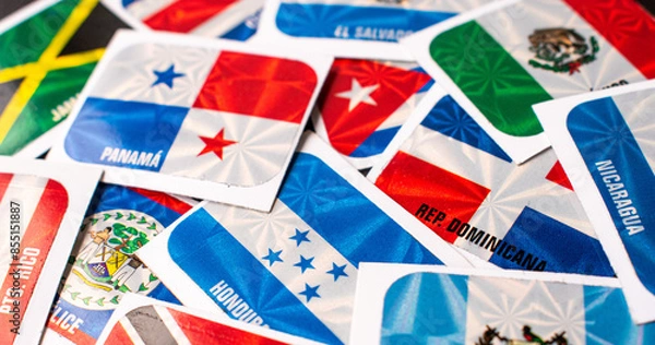 Obraz High angle view of different central america country flag stickers on table
