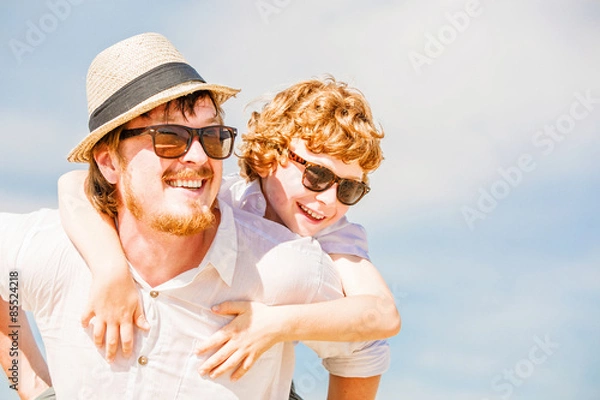Fototapeta Hipster father with beard and red haired son having happy summer