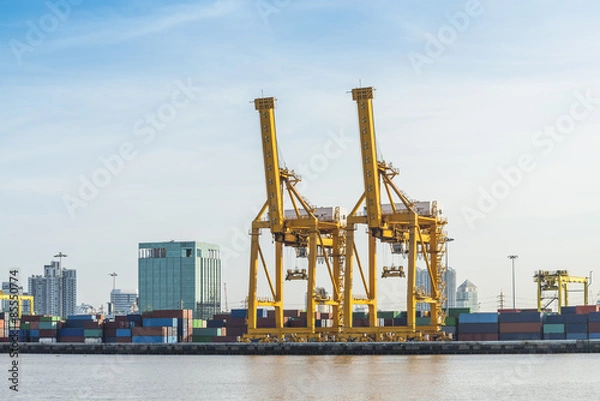 Fototapeta Container loading in a Cargo freight ship with industrial crane. Container ship in import and export business logistic company, a logistics transportation industry concept