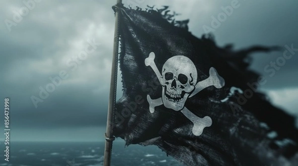 Fototapeta Tattered pirate flag with skull and crossbones against a stormy sky.