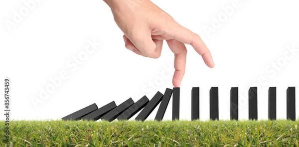 Fototapeta Hand stopping the Domino effect stopped by unique