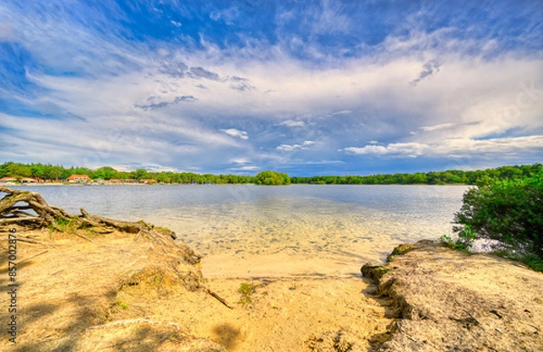 Obraz Big cloud formation floating over lake "De IJzeren Man" in The Netherlands.
