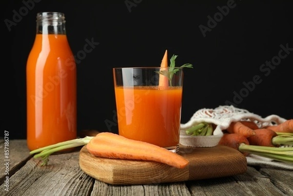 Fototapeta Healthy juice and fresh carrot on wooden table