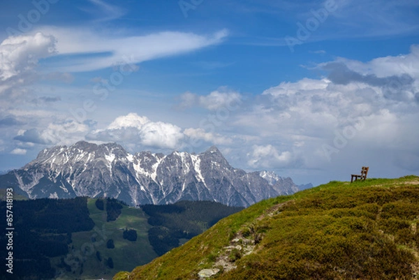 Fototapeta View on a mountain range in Austria, with a sitting bench