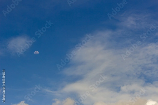 Fototapeta mid moon in the clouds