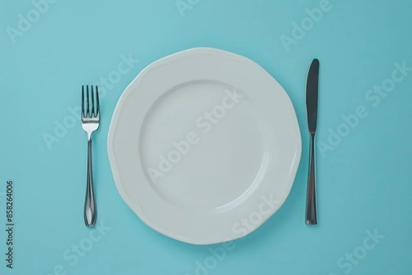 Fototapeta 
empty white plate with knife and fork on blue background