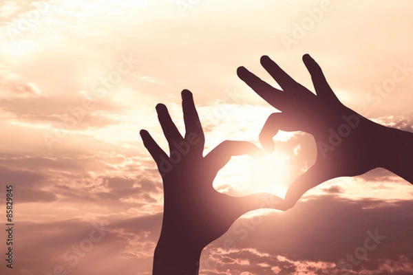 Obraz Silhouette hand in heart shape on sunrise sky and cloud,