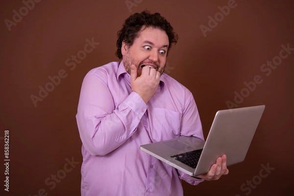 Obraz Funny fat man and online dating. Brown background.